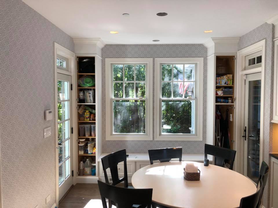 A dining room with a round table and black chairs