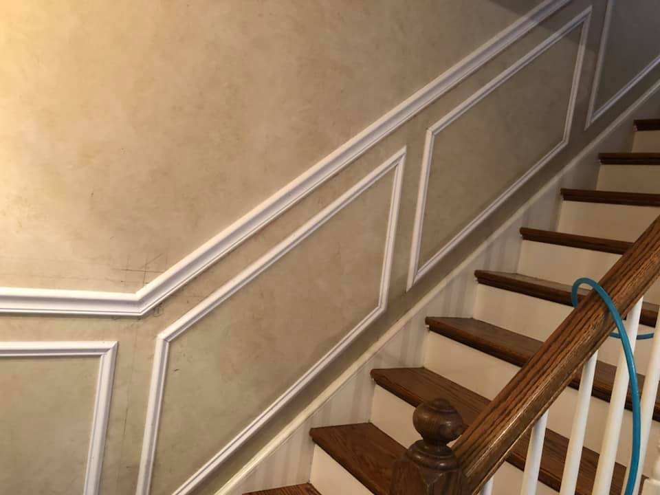 A staircase with wooden steps and a white railing