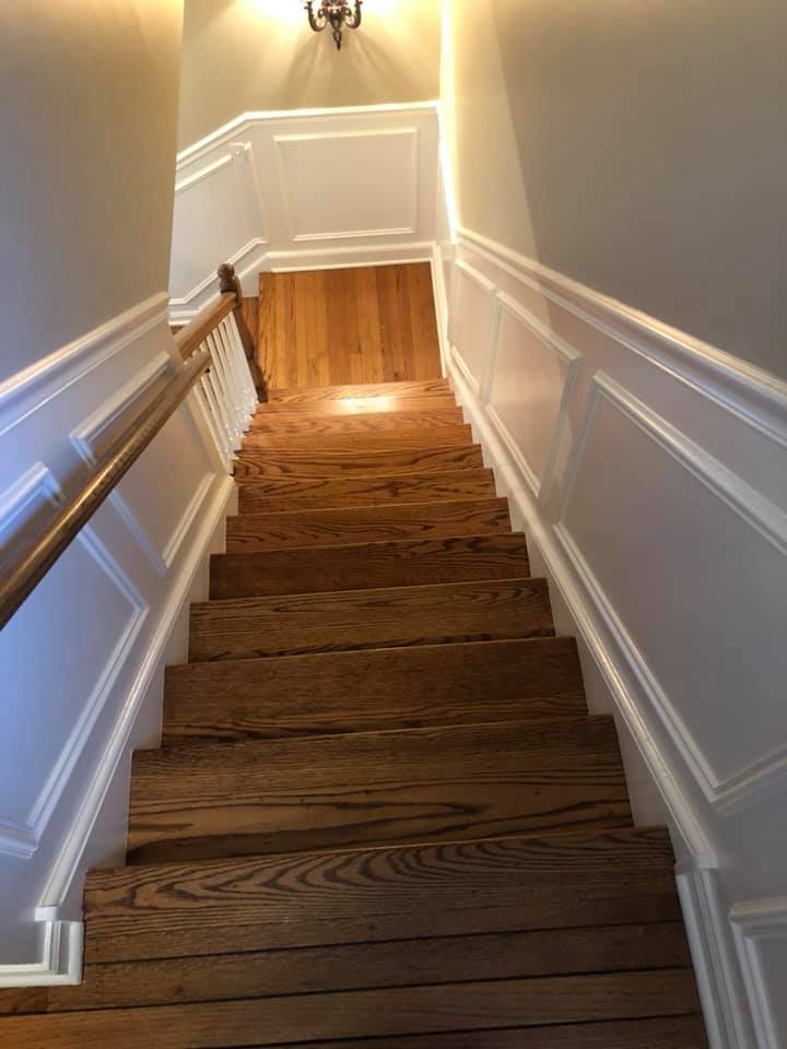 A set of wooden stairs leading up to a second floor in a house.