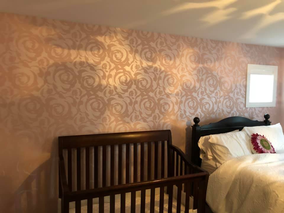 A bedroom with a bed and a crib in it