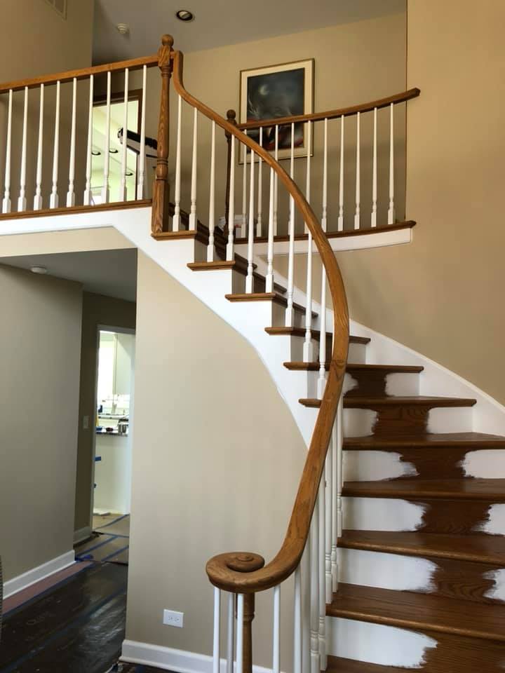 A wooden staircase with white railings in a house