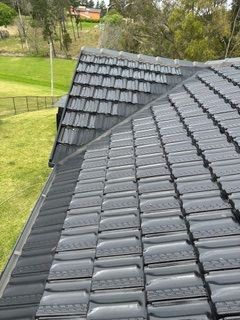 The roof of a house with a lot of tiles on it.