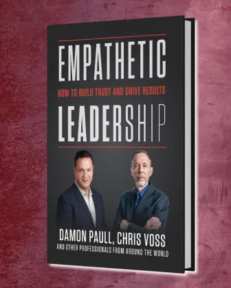 Beach scene with palm trees, rainbow, blue sky, and Diamond Head in the distance.