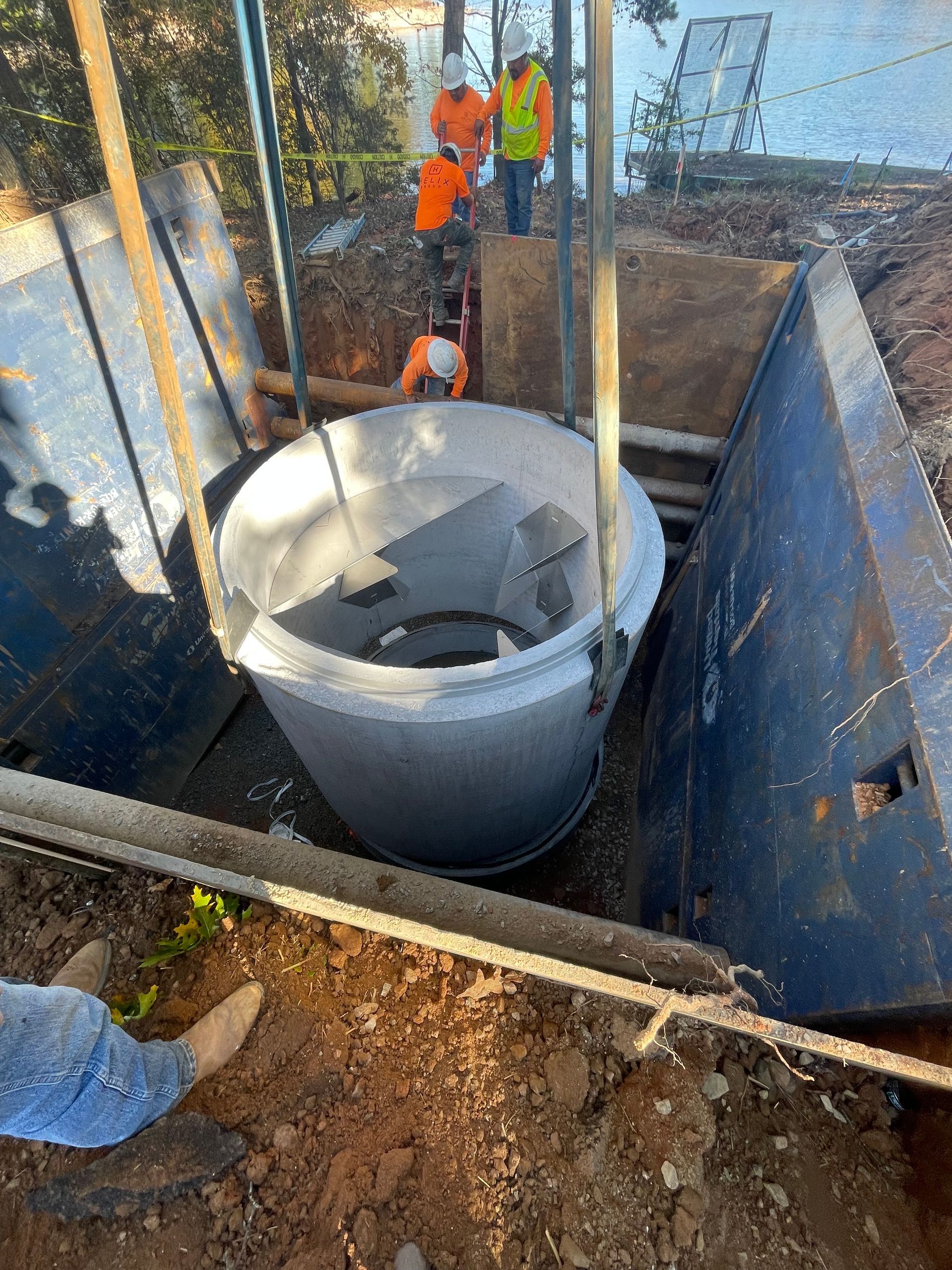 a group of construction workers are working on a septic tank .