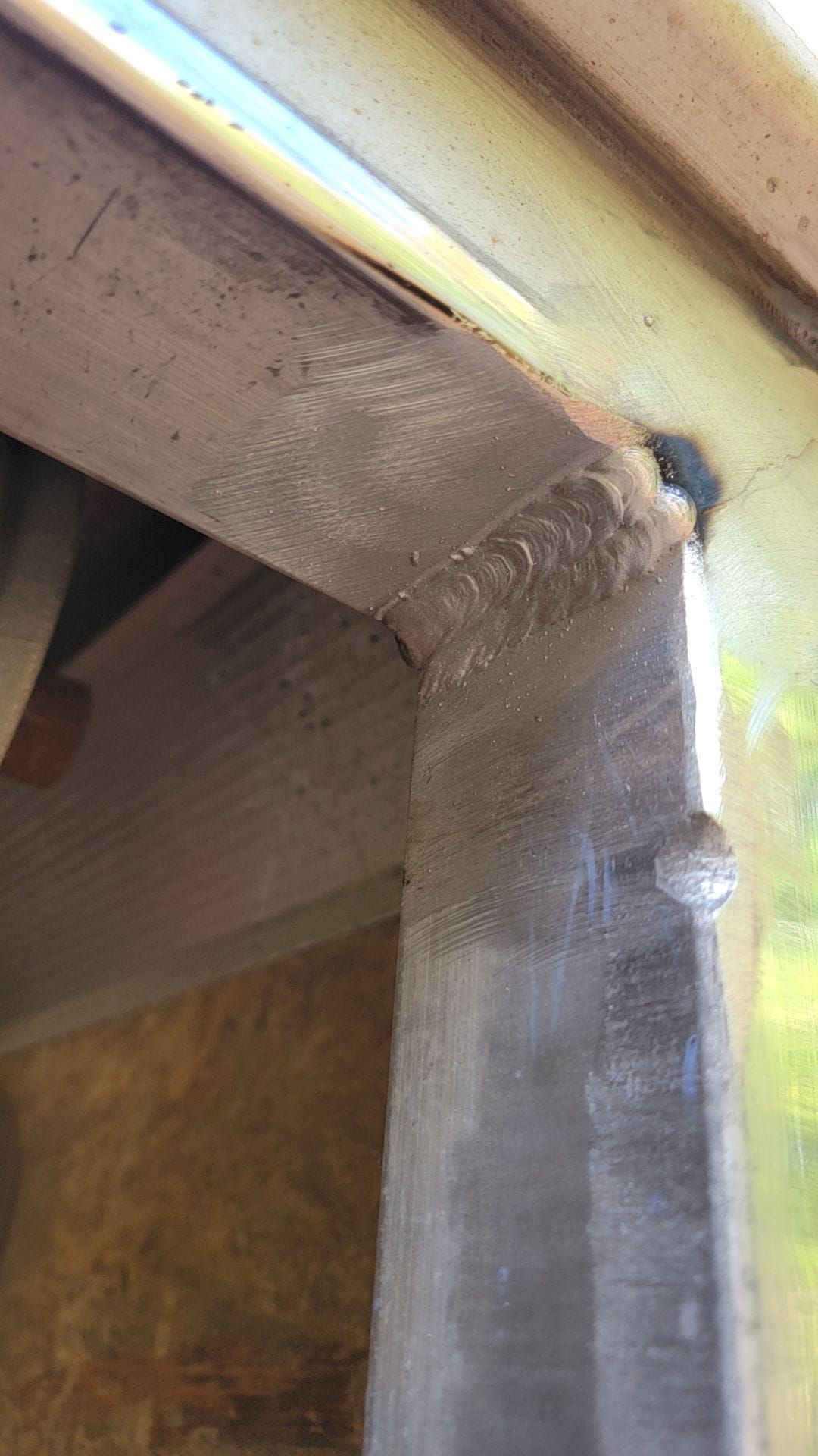 A close up of a window frame with a screw in it.