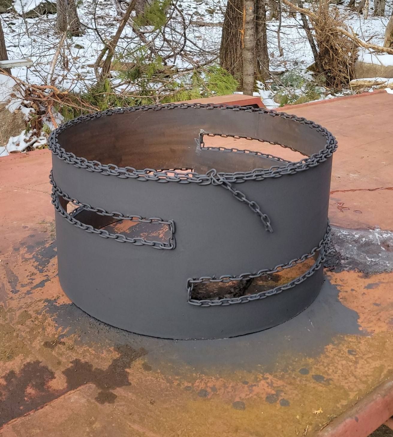 A metal object with chains around it is sitting on a rusty surface