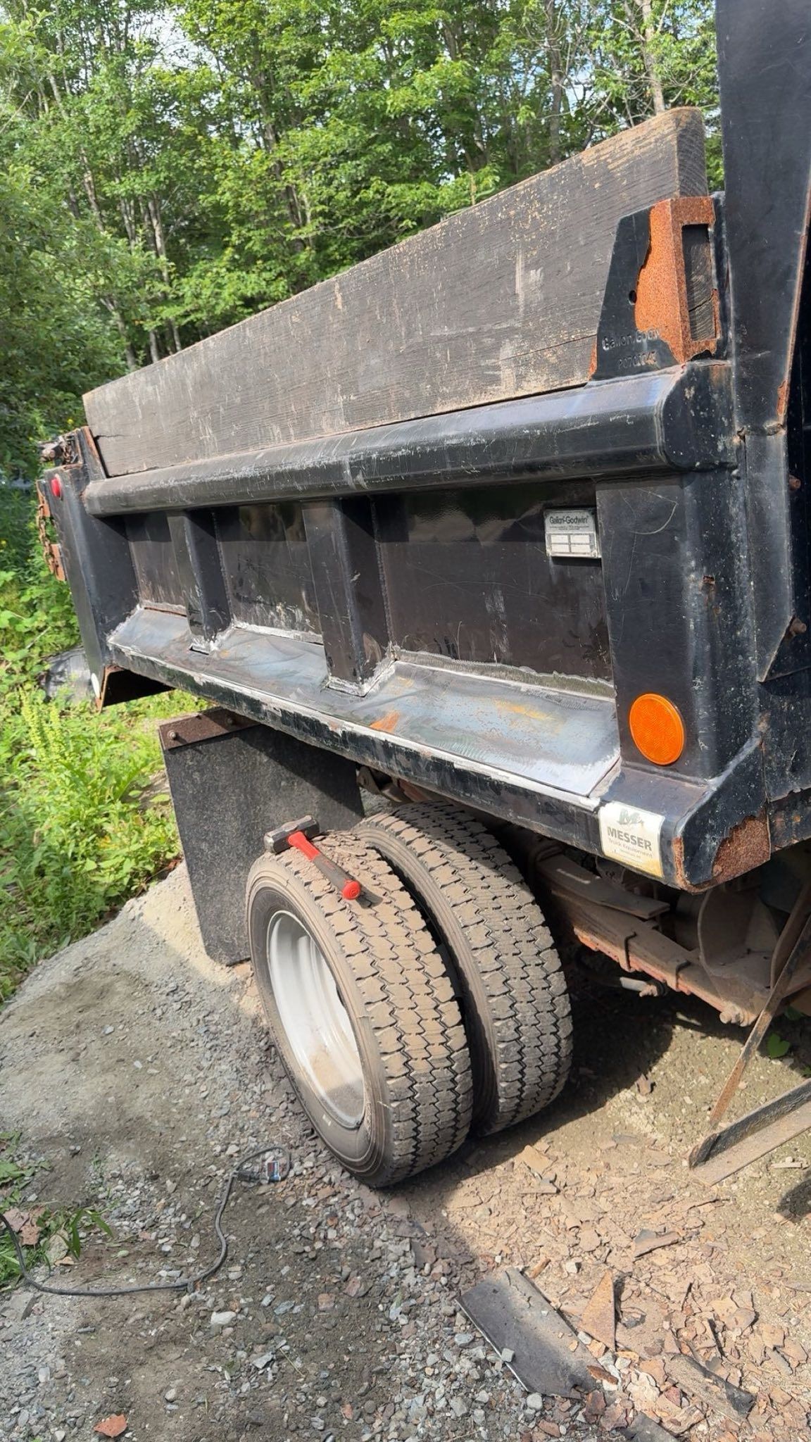 A dump truck is parked on the side of the road.