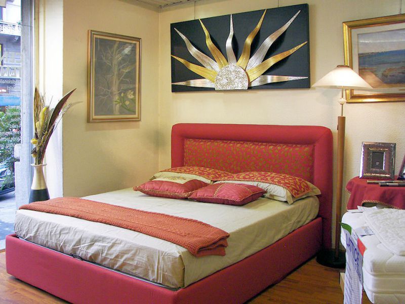 Una camera da letto con un letto e un quadro sul muro