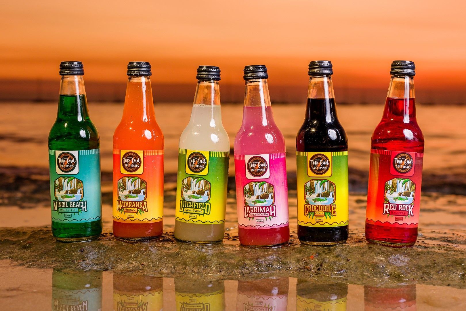 Top End Soft Drinks, with sunset beach background