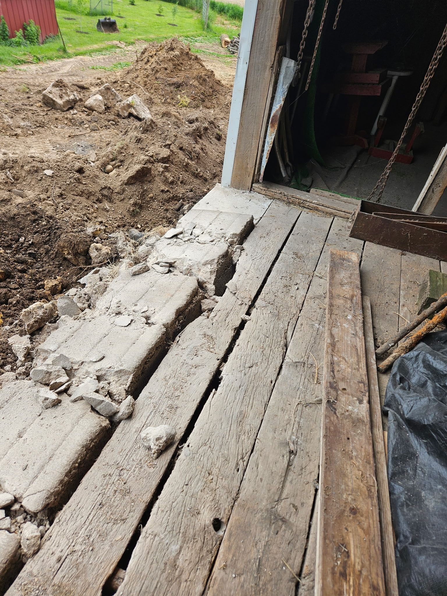 A wooden deck is sitting in front of a garage door.