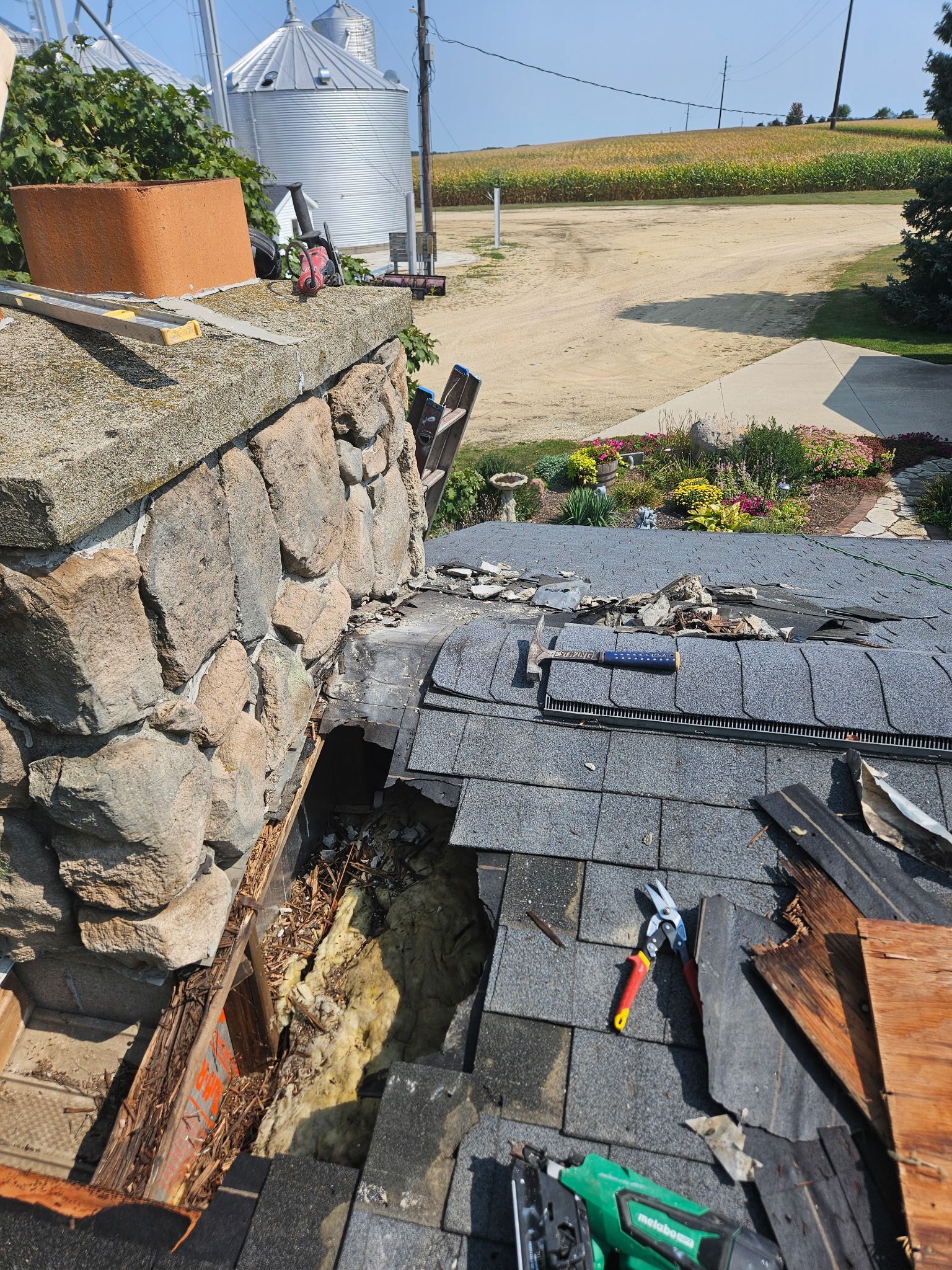 A roof with a hole in it is being repaired.