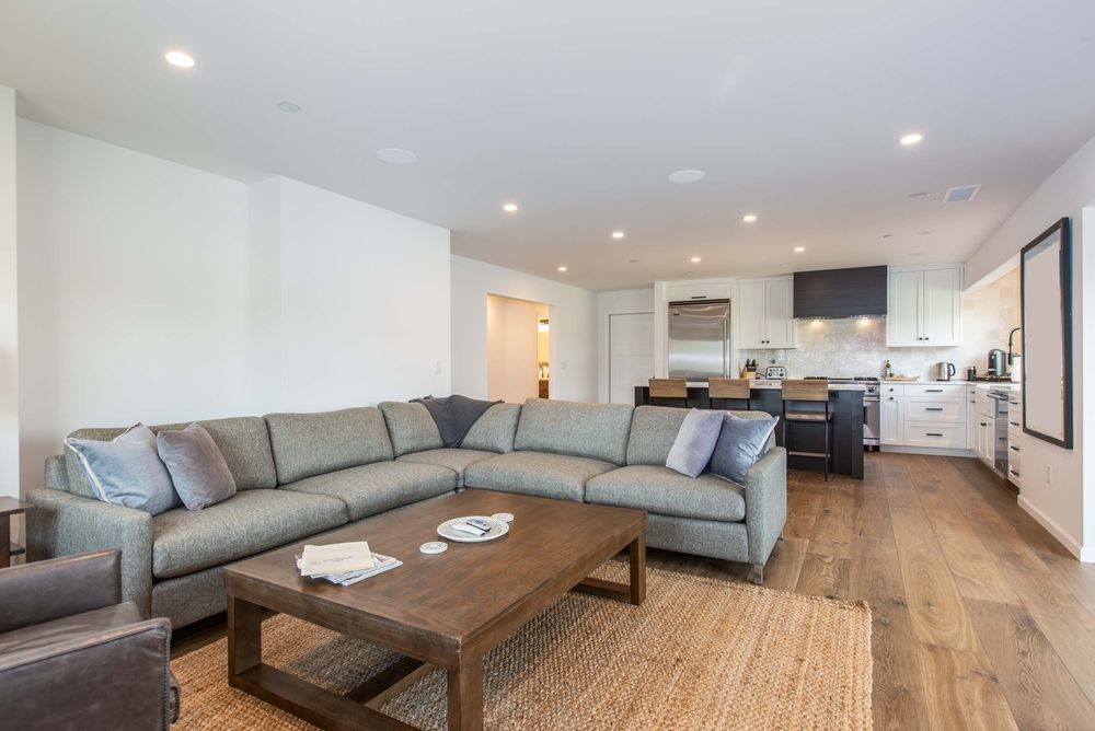 A living room with a large sectional couch and a coffee table.