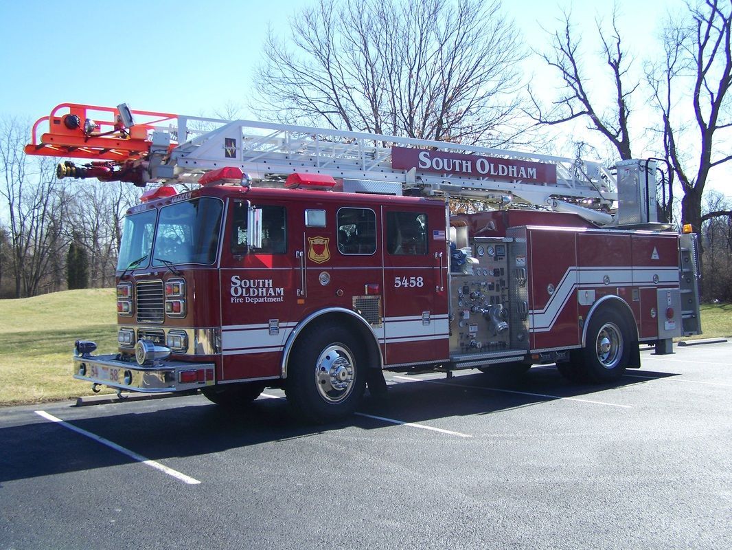 A red south district fire truck is parked in a parking lot