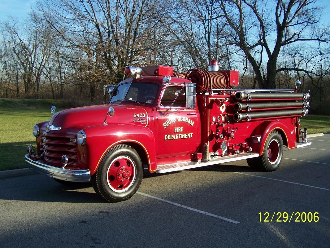 A red fire truck is parked on the side of the road