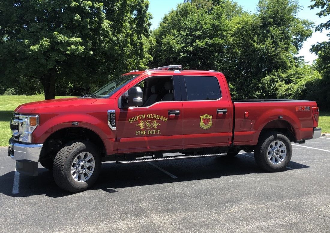 A red pickup truck is parked on the side of the road.