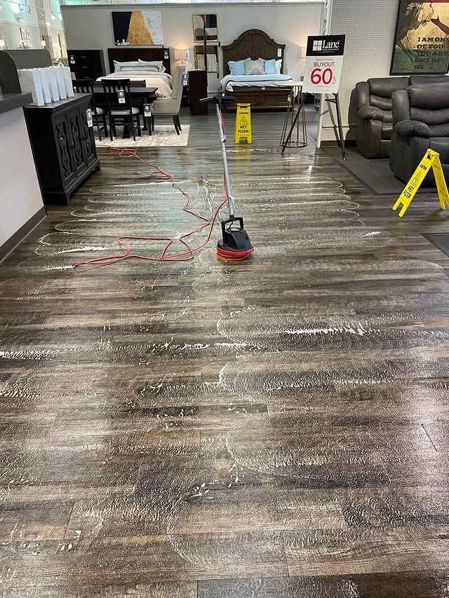 A vacuum cleaner is sitting on a wooden floor in a room.
