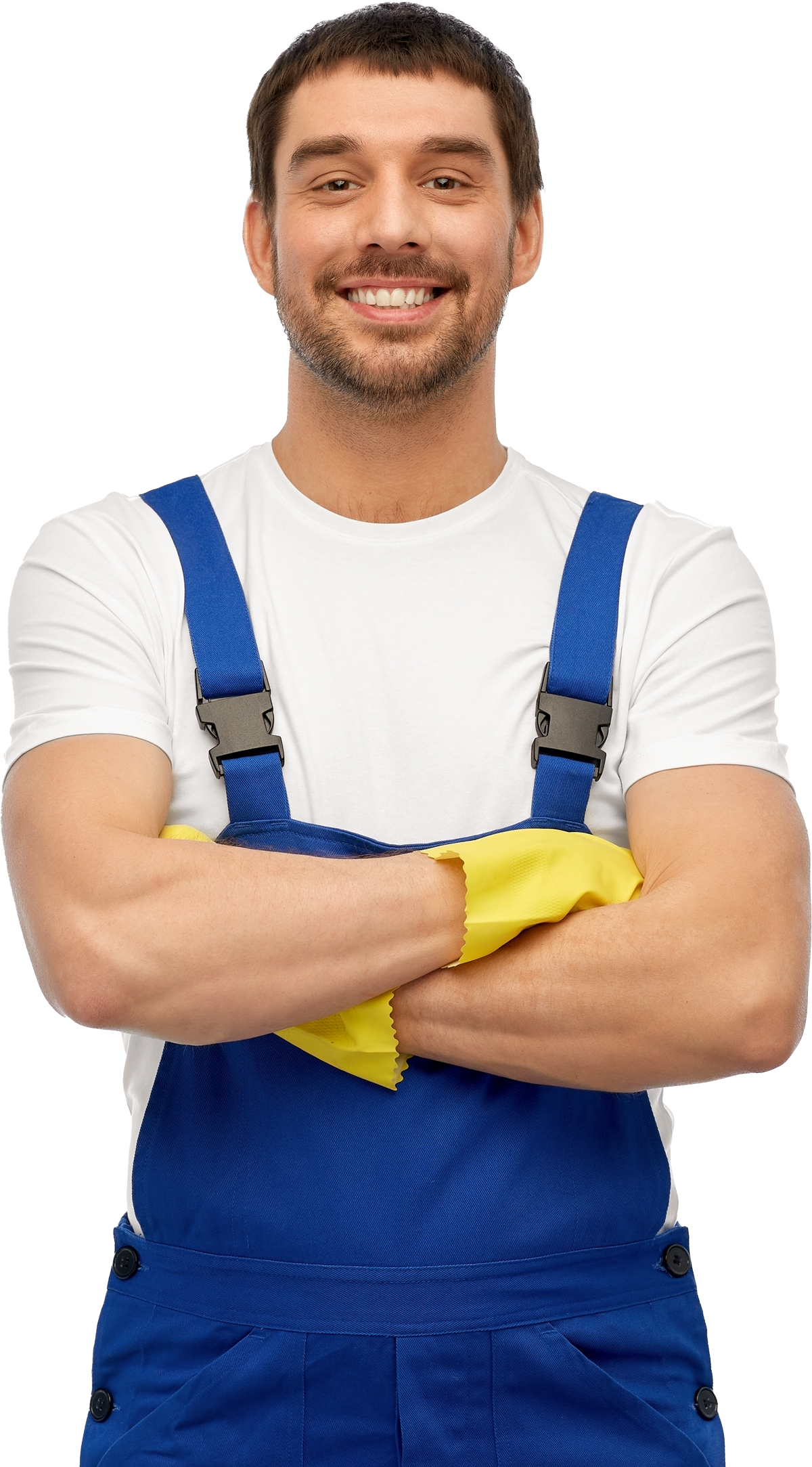 A man in blue overalls and yellow gloves is smiling with his arms crossed.