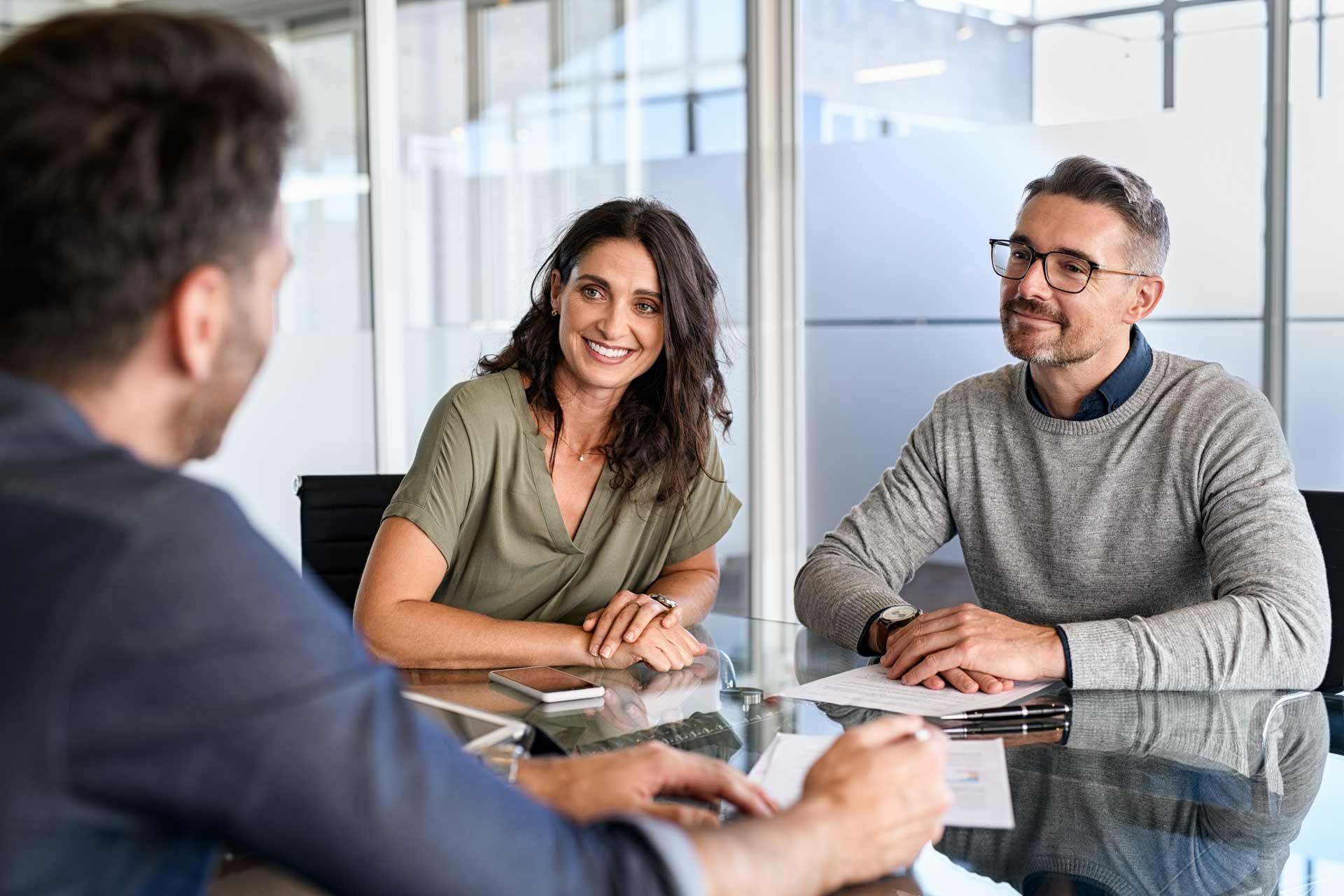 A man and a woman are sitting at a table having a meeting