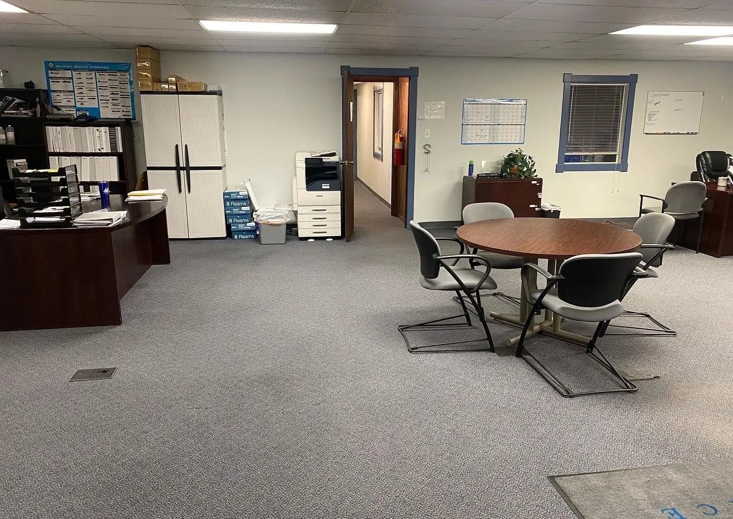 A large room with a table and chairs in it