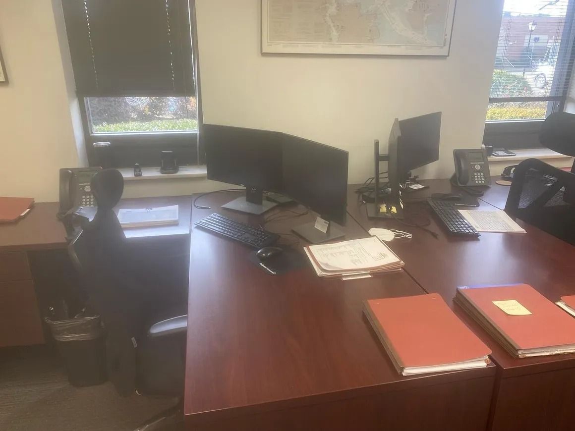 A desk with a computer and a book on it