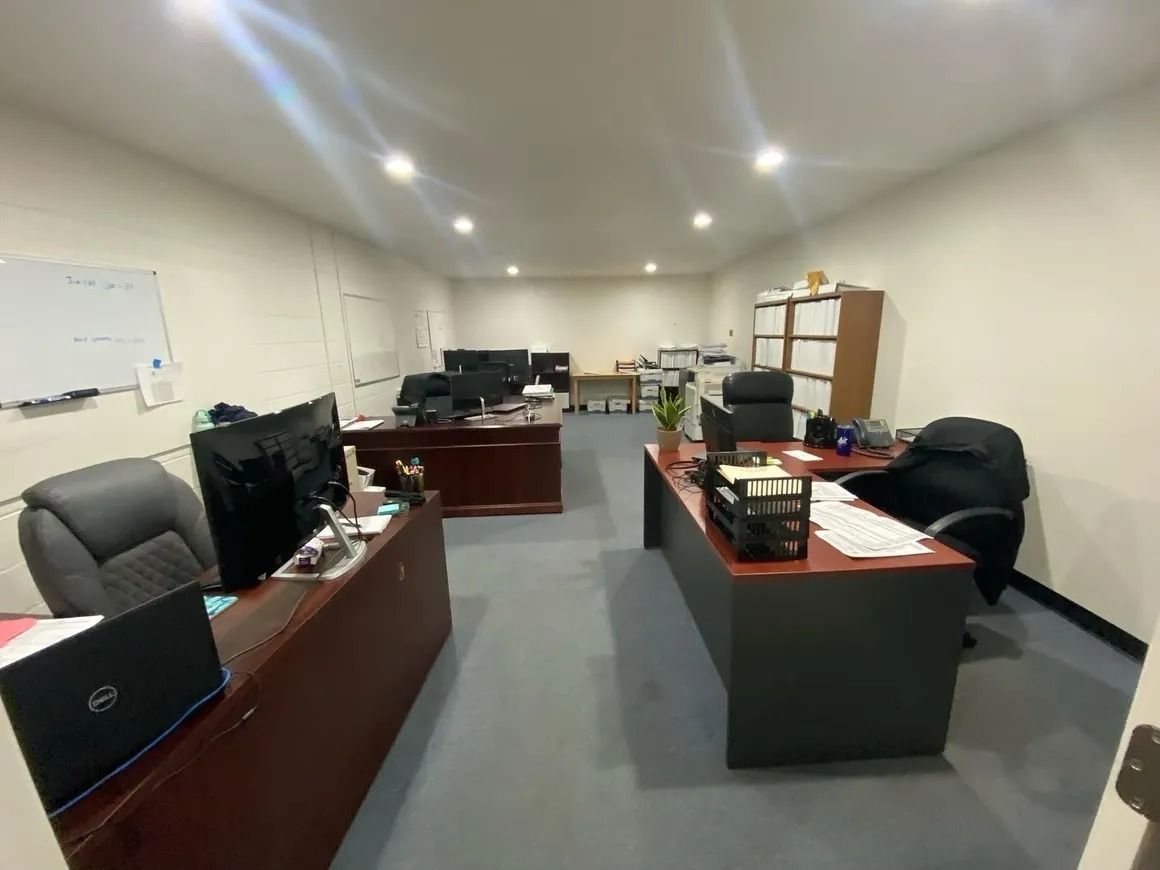 A large office with a lot of desks and chairs.