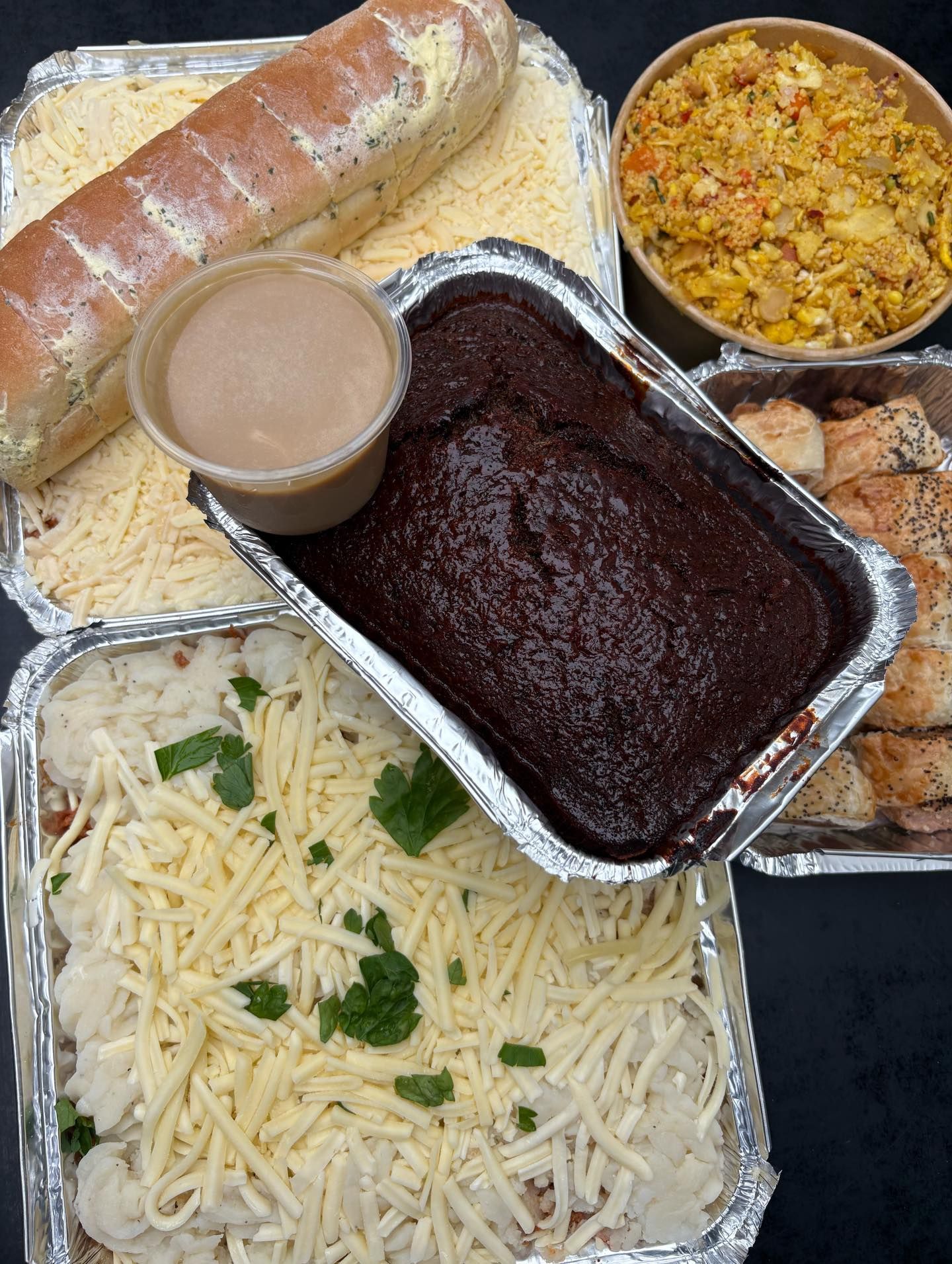 Variety of prepared foods: bread, casseroles, fried rice, and brownie with gravy.