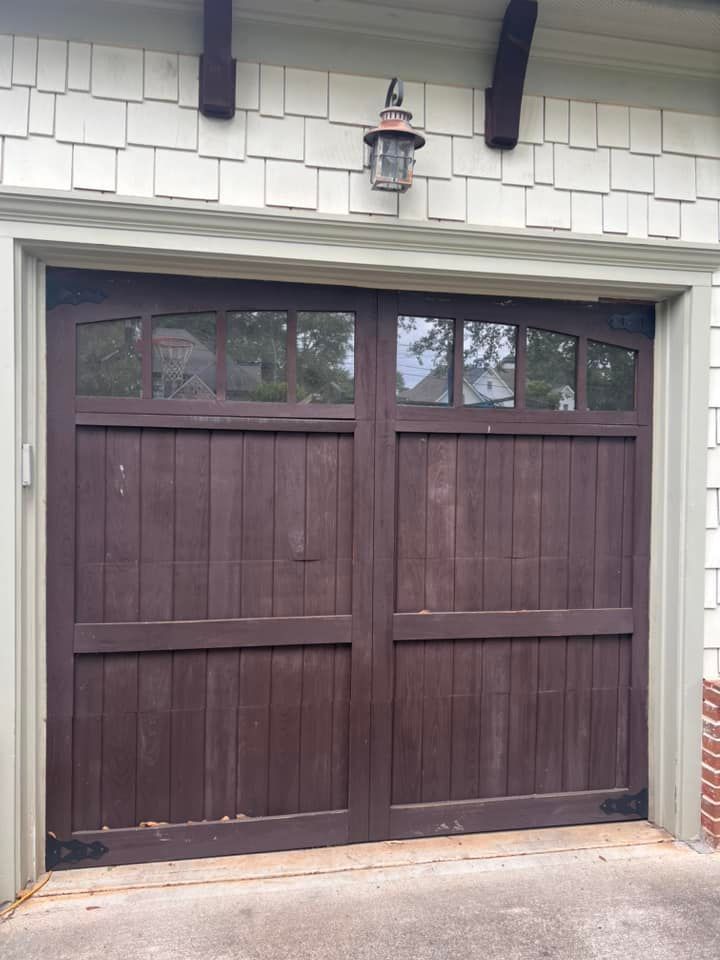 A brown wooden garage door with a light above it