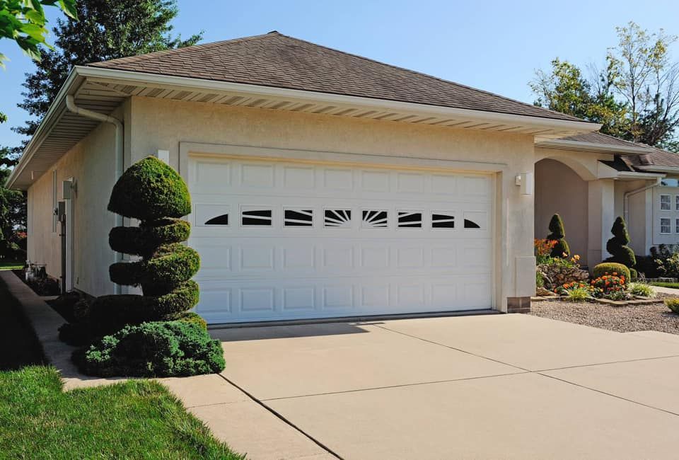 A white house with a large white garage door