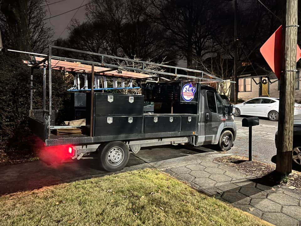 A truck is parked on the side of the road at night.