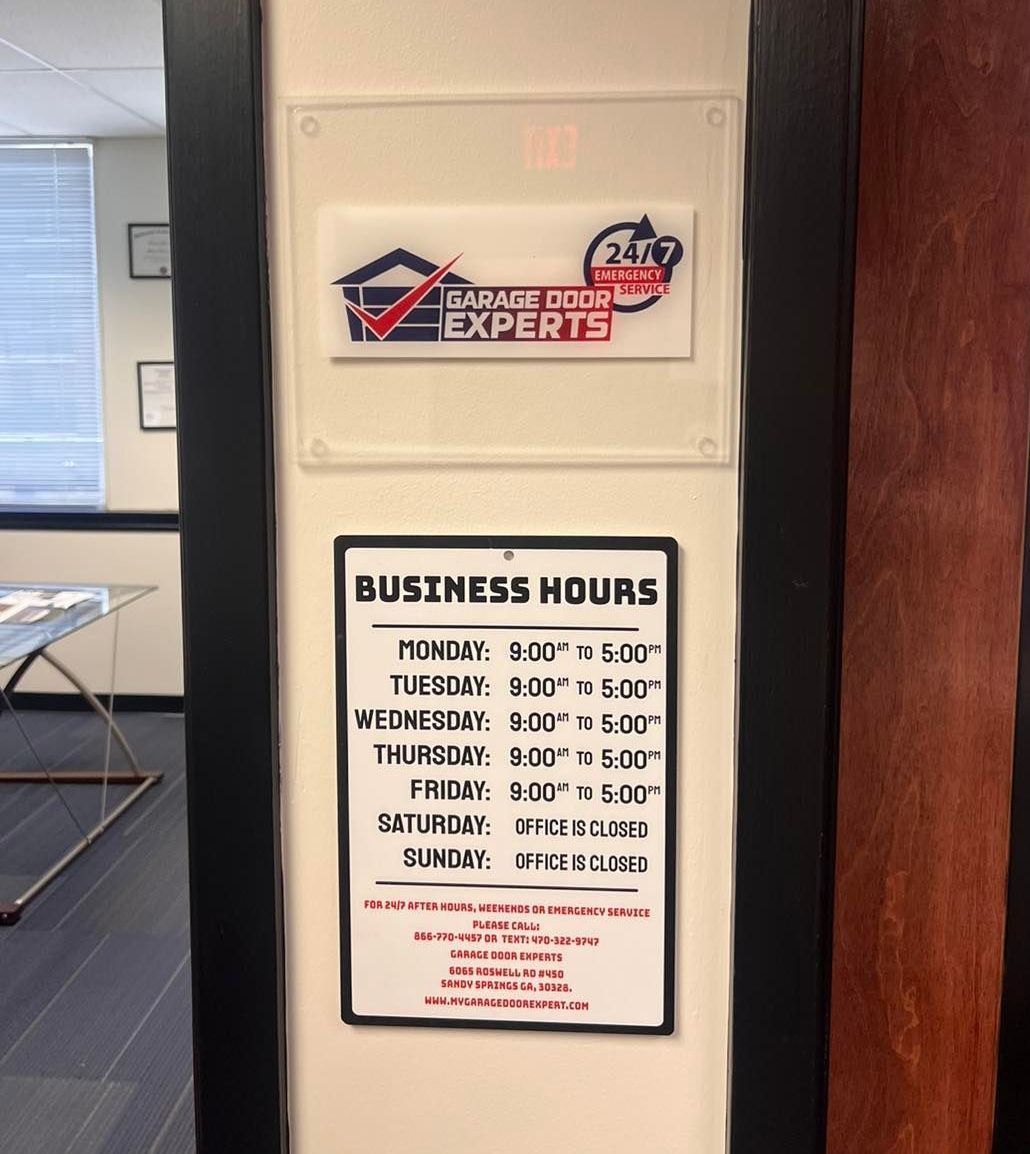 A sign on a wall that says business hours