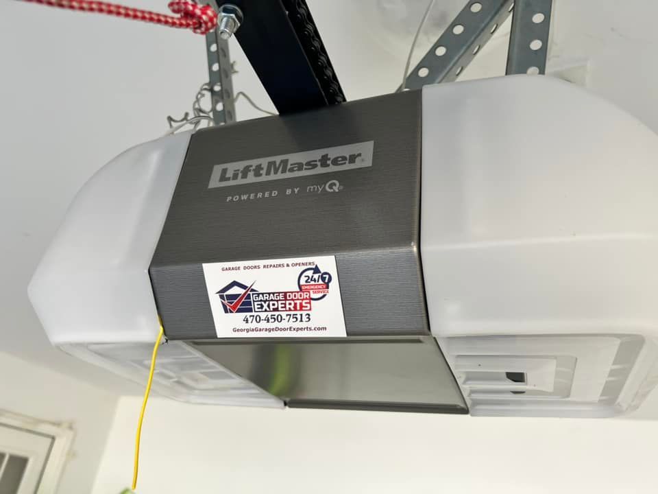 A liftmaster garage door opener is hanging from the ceiling