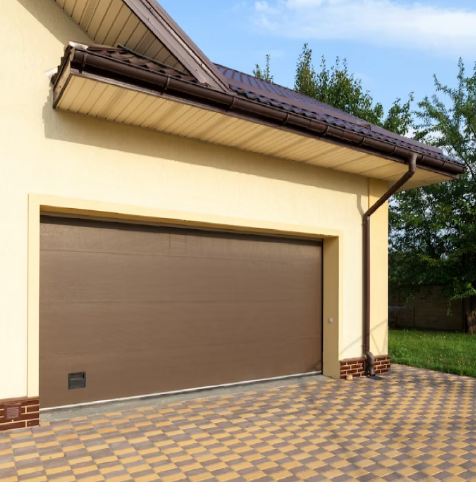 A wooden garage door with a clock on the wall in a room.