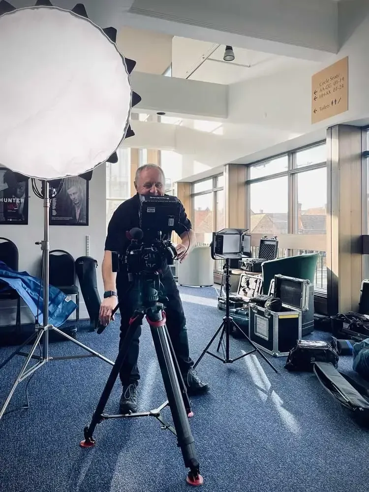 A baby is sitting upside down on a white chair.