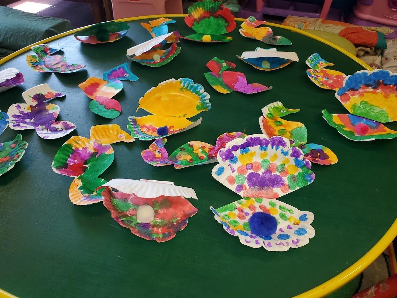 A table with a lot of colorful paper plates on it