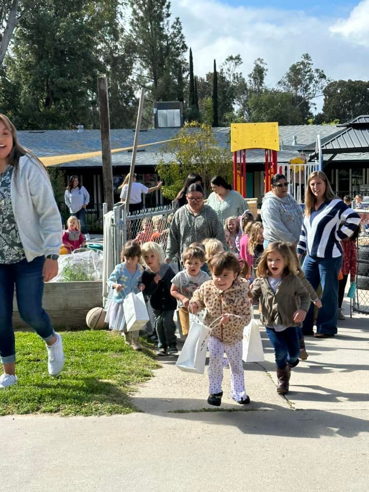 A group of children are walking down a sidewalk.