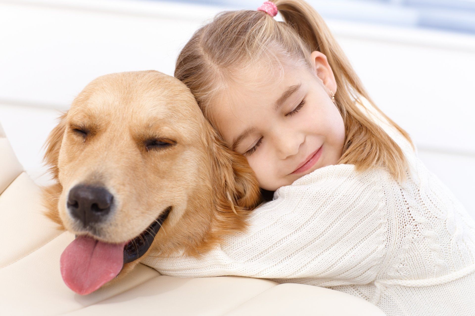 Young Girl cuddles her beloved dog