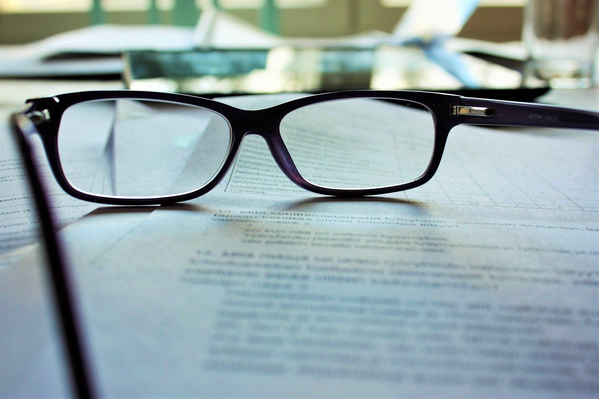 Glasses lying on a policy document