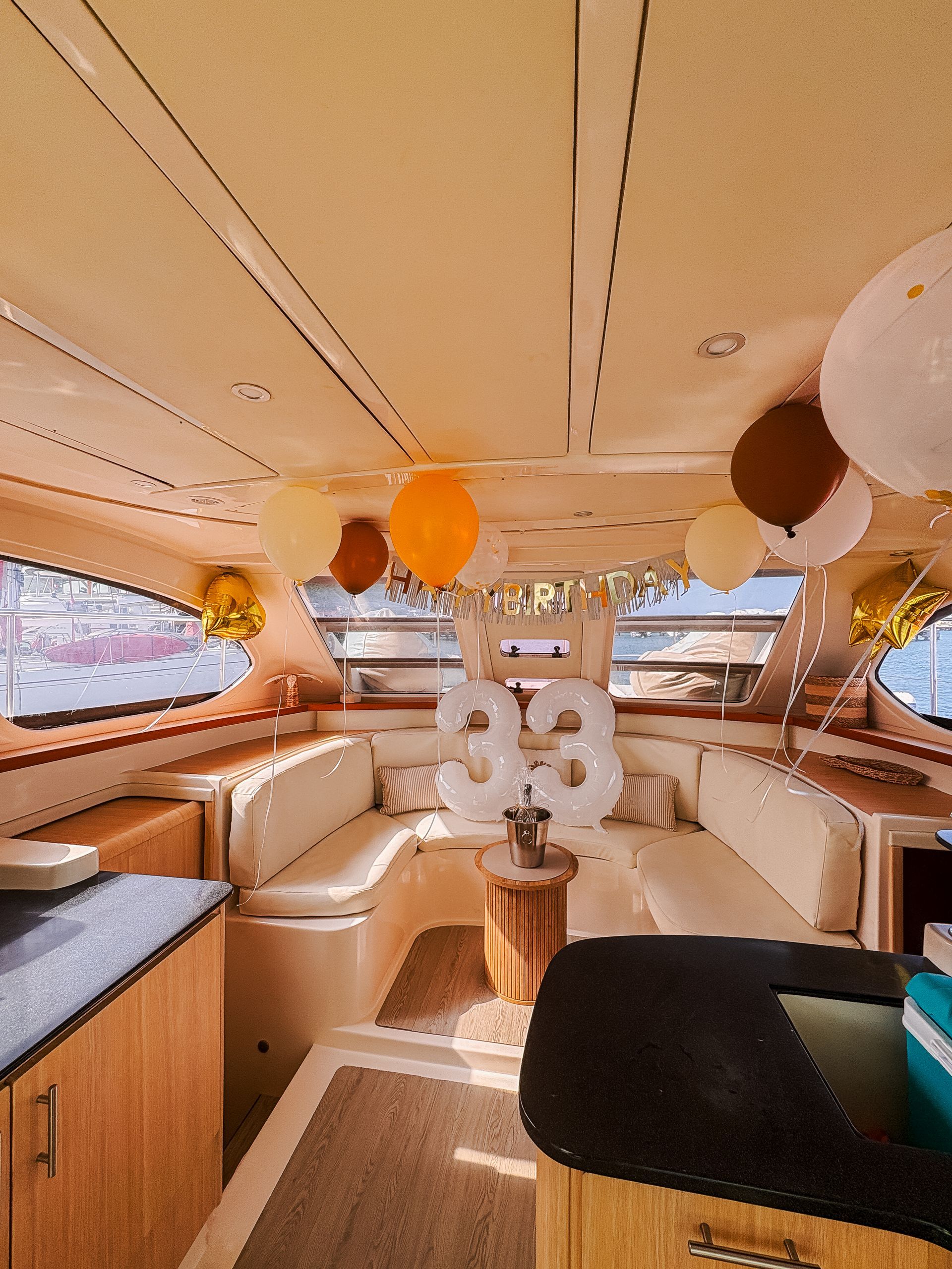 Interior of a boat decorated with balloons for a 93rd birthday celebration.