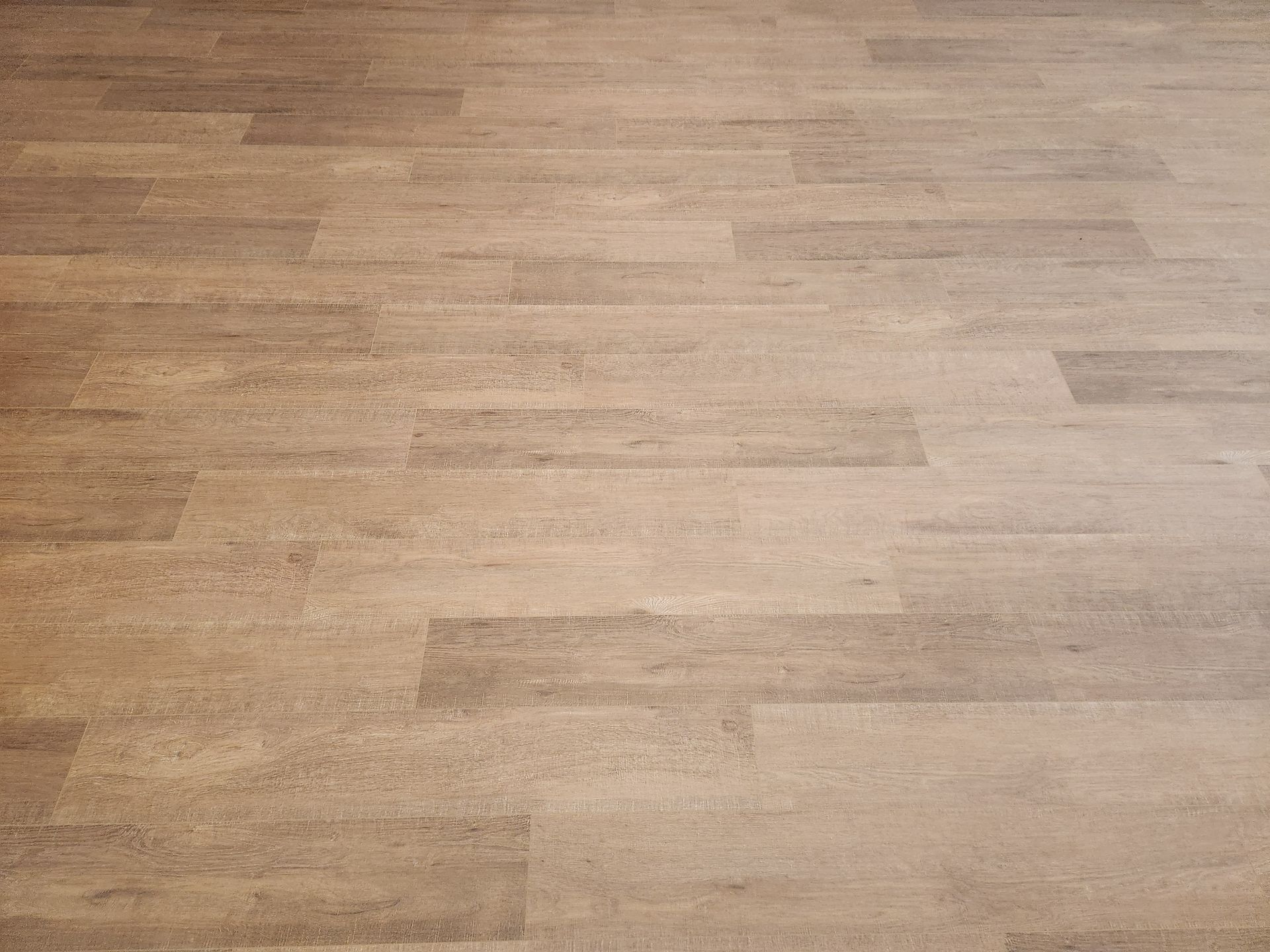 Light wood-grain floor with a smooth, empty surface.
