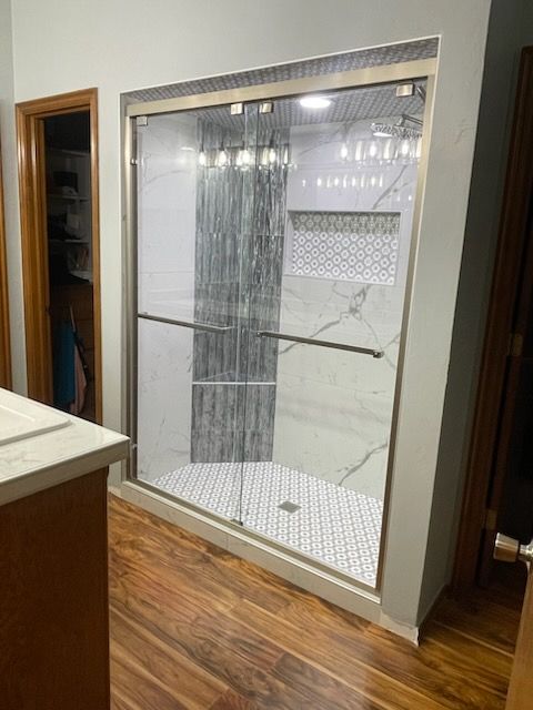 Large white display enclosure with wire mesh front in a wood-floored room, viewed from a doorway