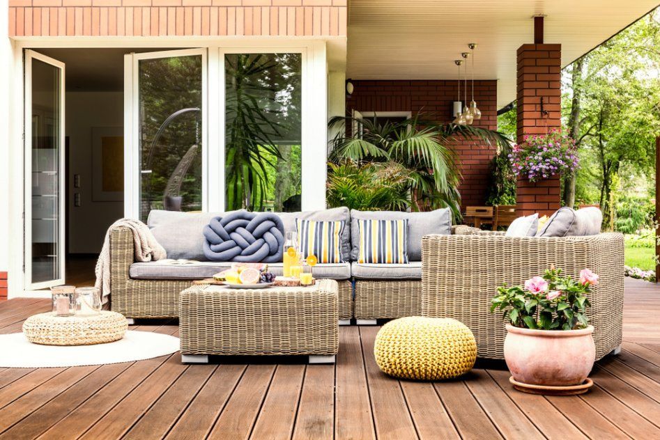 A Patio with A Couch, Chairs, Table and Potted Plants — Cachia Upholstery in Tuncurry, NSW