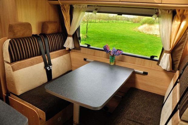 The Inside of A Camper Van with A Table and A Window — Cachia Upholstery in Tuncurry, NSW