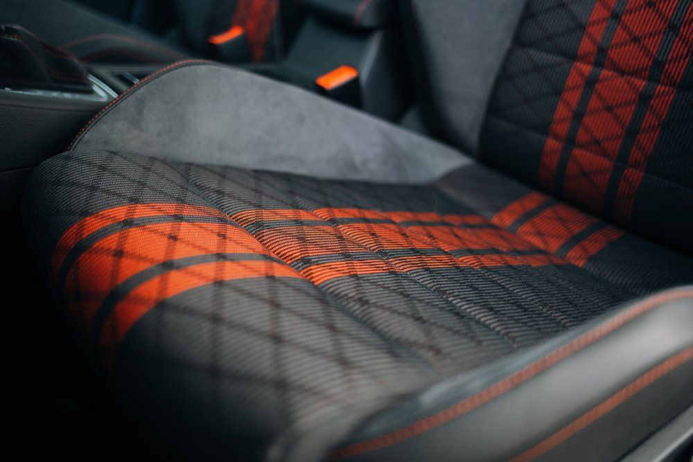 A Close up Of a Car Seat with A Red Stripe on It — Cachia Upholstery in Tuncurry, NSW