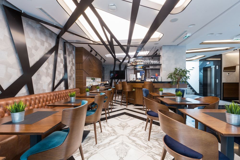 Modern Restaurant Interior With Wooden Tables — Cachia Upholstery in Tuncurry, NSW