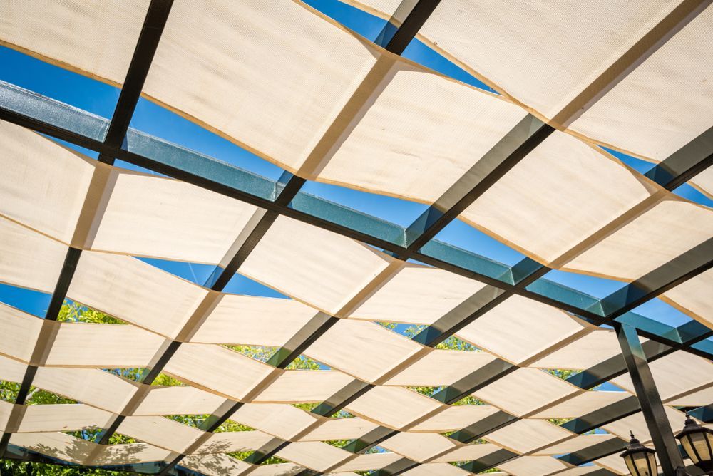 Sunlit Canopy of White Fabric Panels — Cachia Upholstery in Port Macquarie, NSW