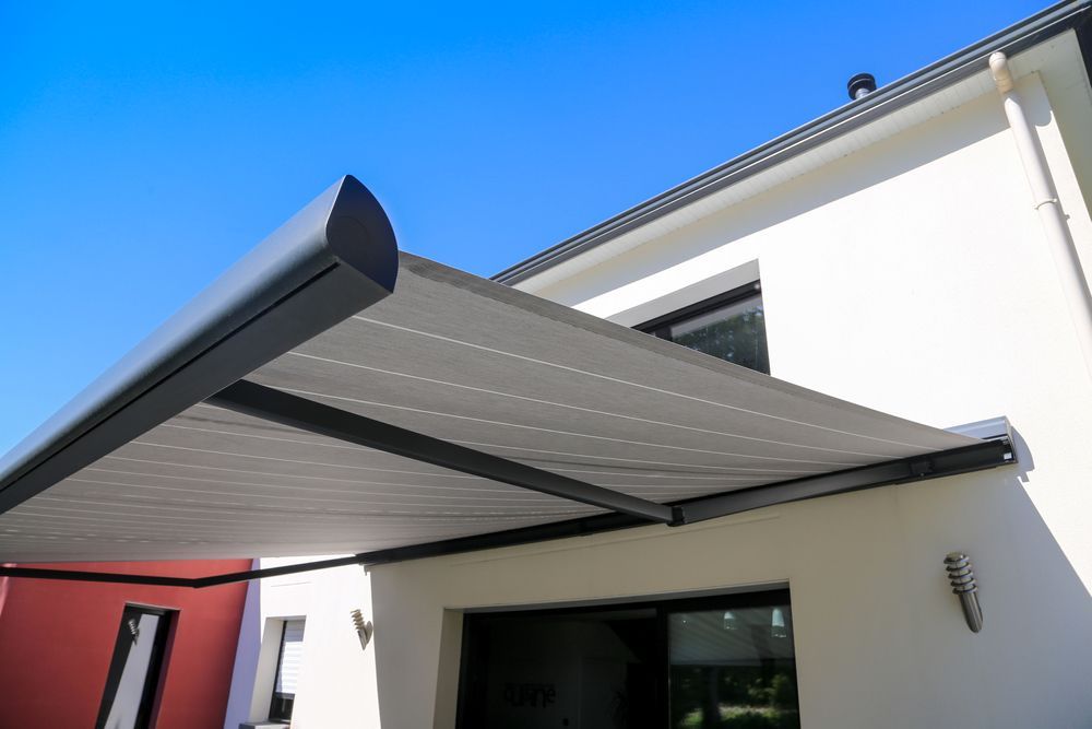 Retractable Gray Awning Extending Over a Patio — Cachia Upholstery in Forster, NSW