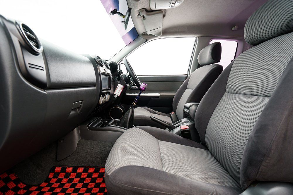 The Interior of A Car with Two Seats and A Checkered Floor Mat — Cachia Upholstery in Tuncurry, NSW