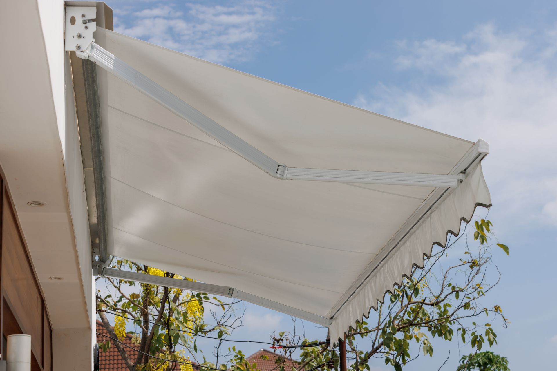 White Retractable Awning Extended Over a Patio — Cachia Upholstery in Port Macquarie, NSW