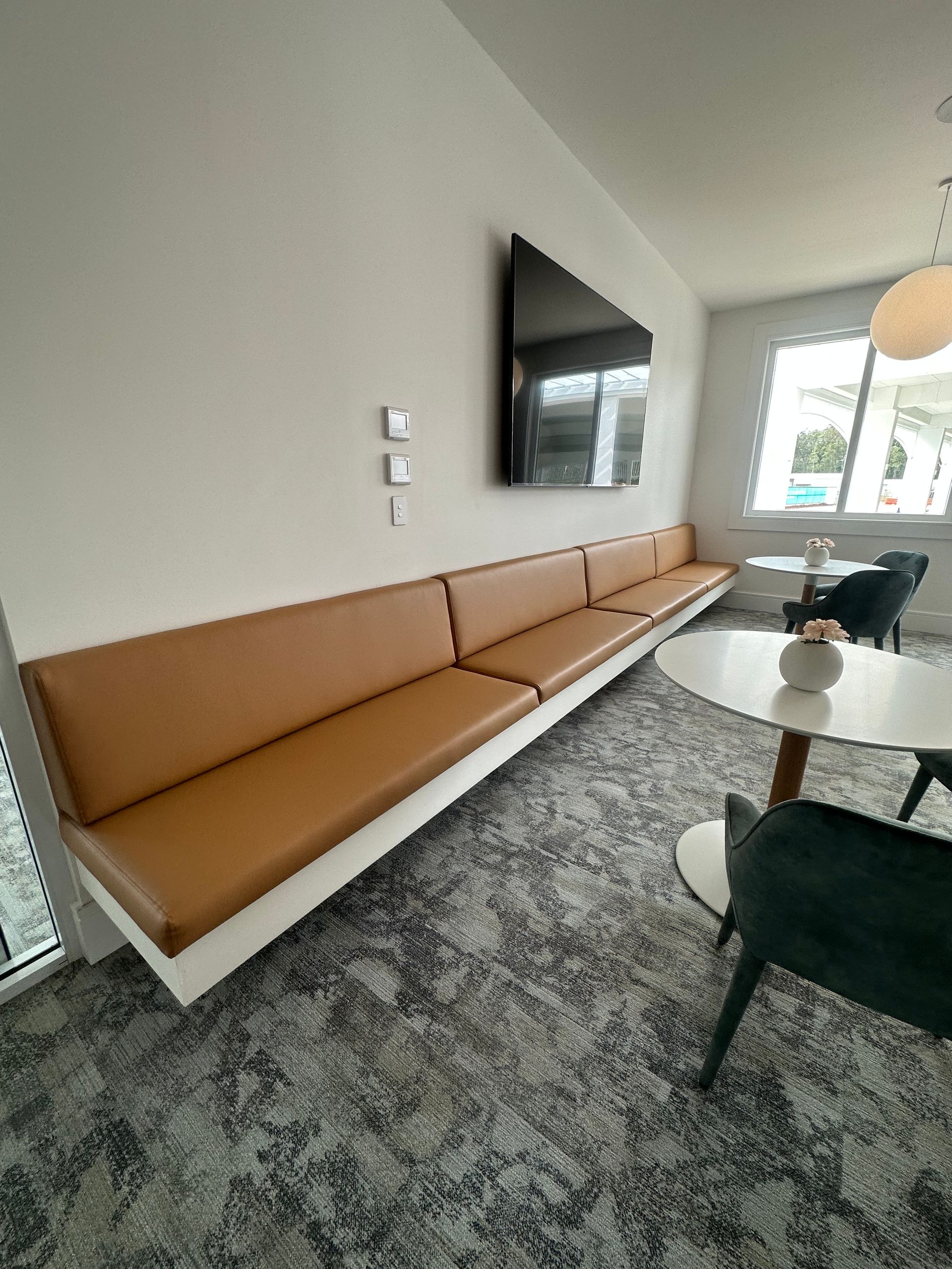 A Living Room with A Couch, Chair, Coffee Table and Brick Wall — Cachia Upholstery in Port Macquarie, NSW