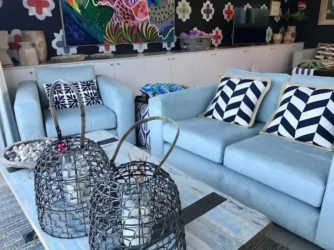 A Living Room with A Blue Couch and Black and White Pillows — Cachia Upholstery in Tuncurry, NSW